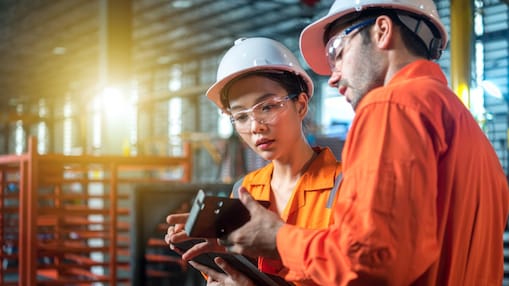 Two engineers looking at a tablet
