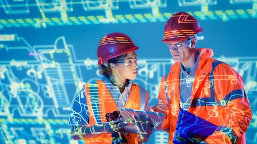 Two engineers looking at digital screen