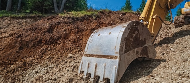 Close up of digger pulling up ground
