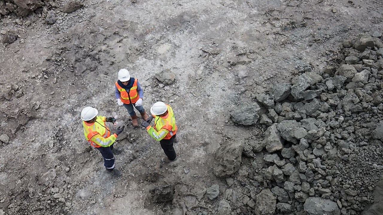 Birds eye view of 3 engineers on a construction site