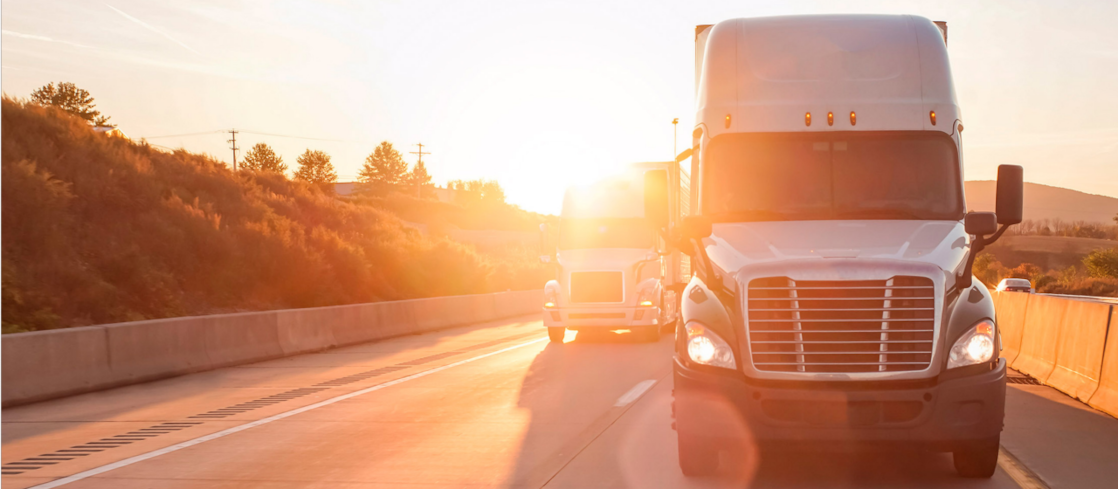 Large truck driving into the sun