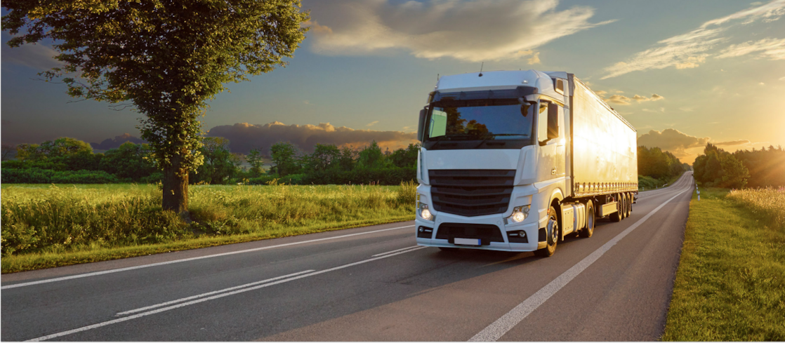 Truck driving at sunset