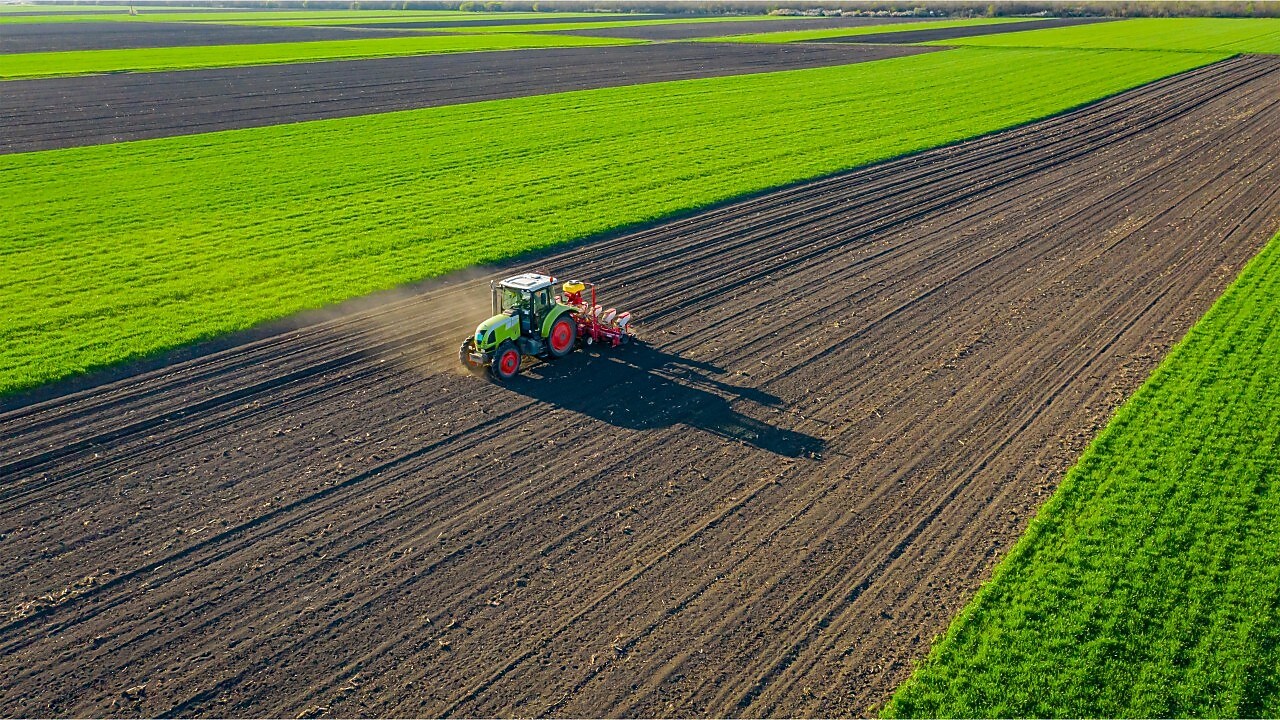 Tractor working crop field