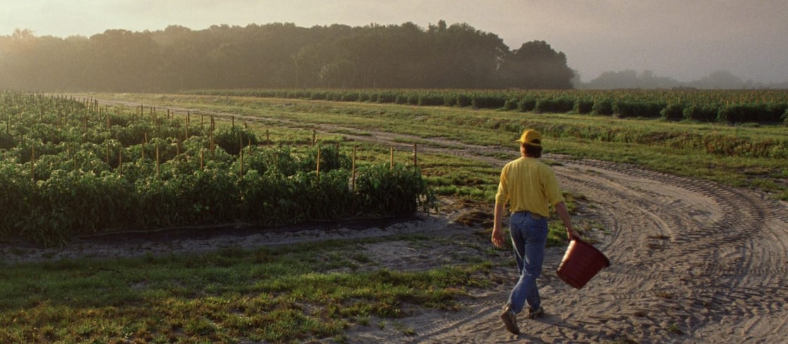Farmer carrying a bucket 