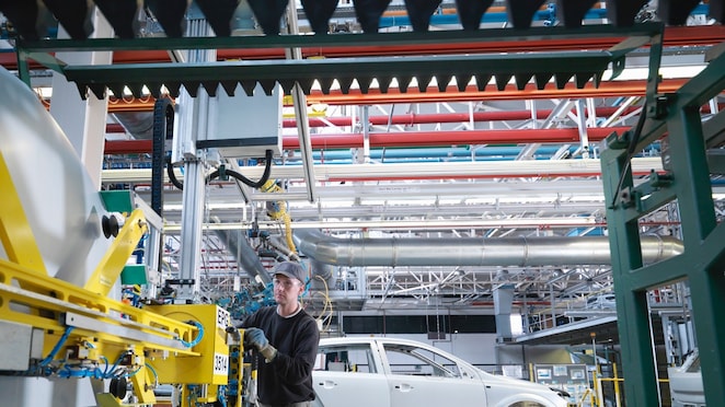 Worker on auto factory production line