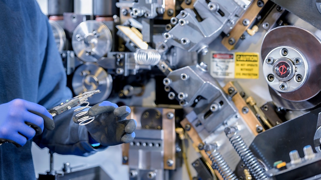 Car factory worker inspecting components