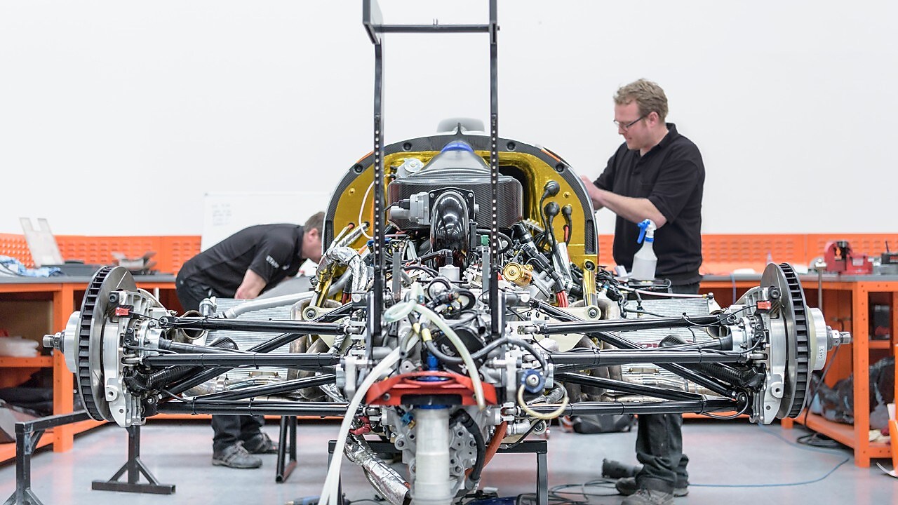 Workers manufacturing car