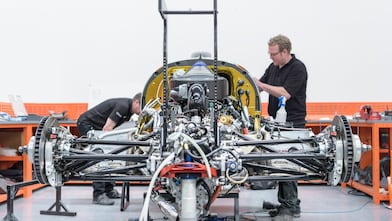 Workers manufacturing car