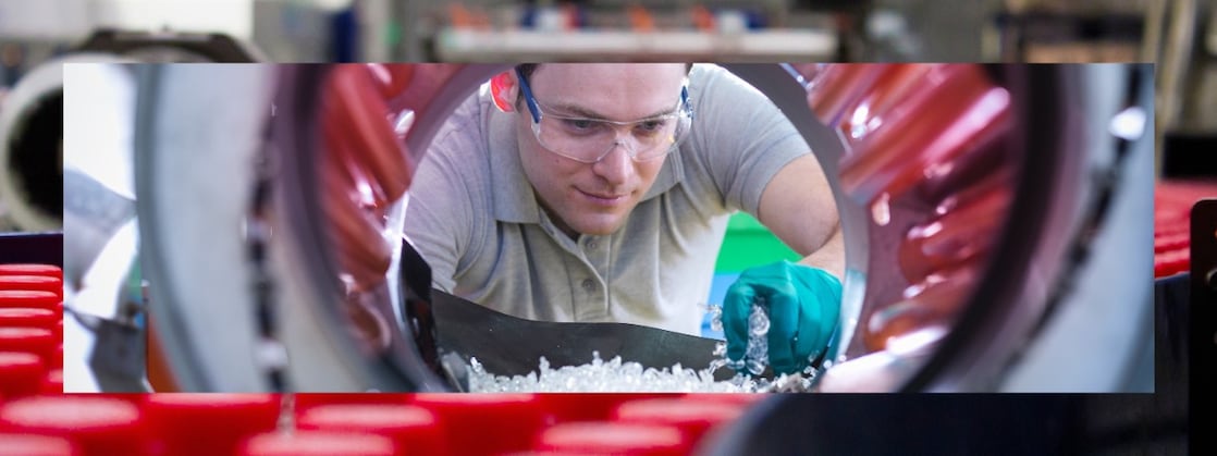 Factory worker with plastics manufacturing equipment