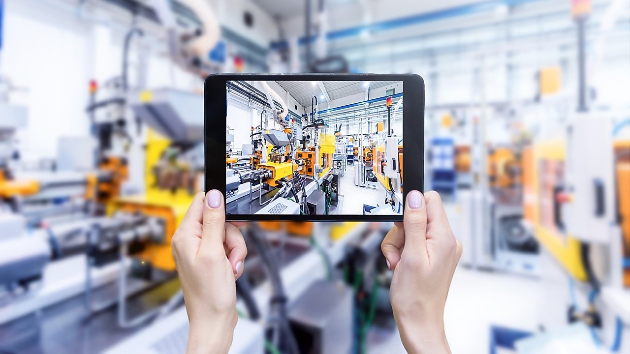 Plastic injection moulding equipment viewed on ipad screen