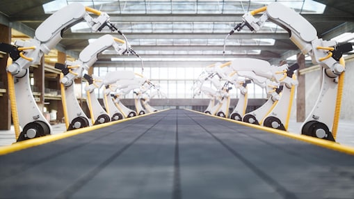 Series of robotic arms on assembly line