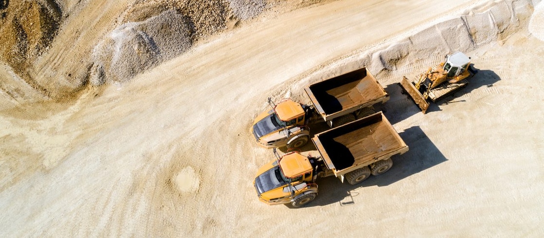 Two mining trucks driving