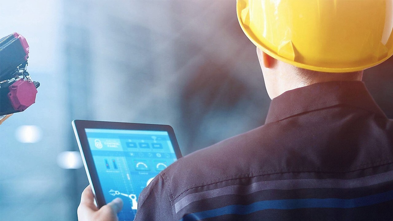 Man in hard hat on tablet