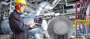 Engineer using laptop computer for maintenance in thermal power plant