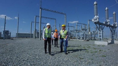 Group of engineers walking on solar station platform