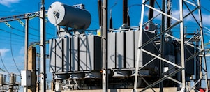 Close up of a transformer with bright yellow sparks above the transformer