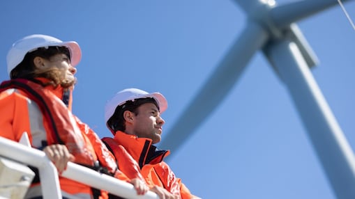 Wind technician standing outside of wind turbine