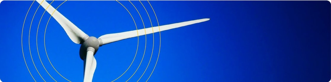 Wind turbine on blue background with 4 yellow rings above the turbine