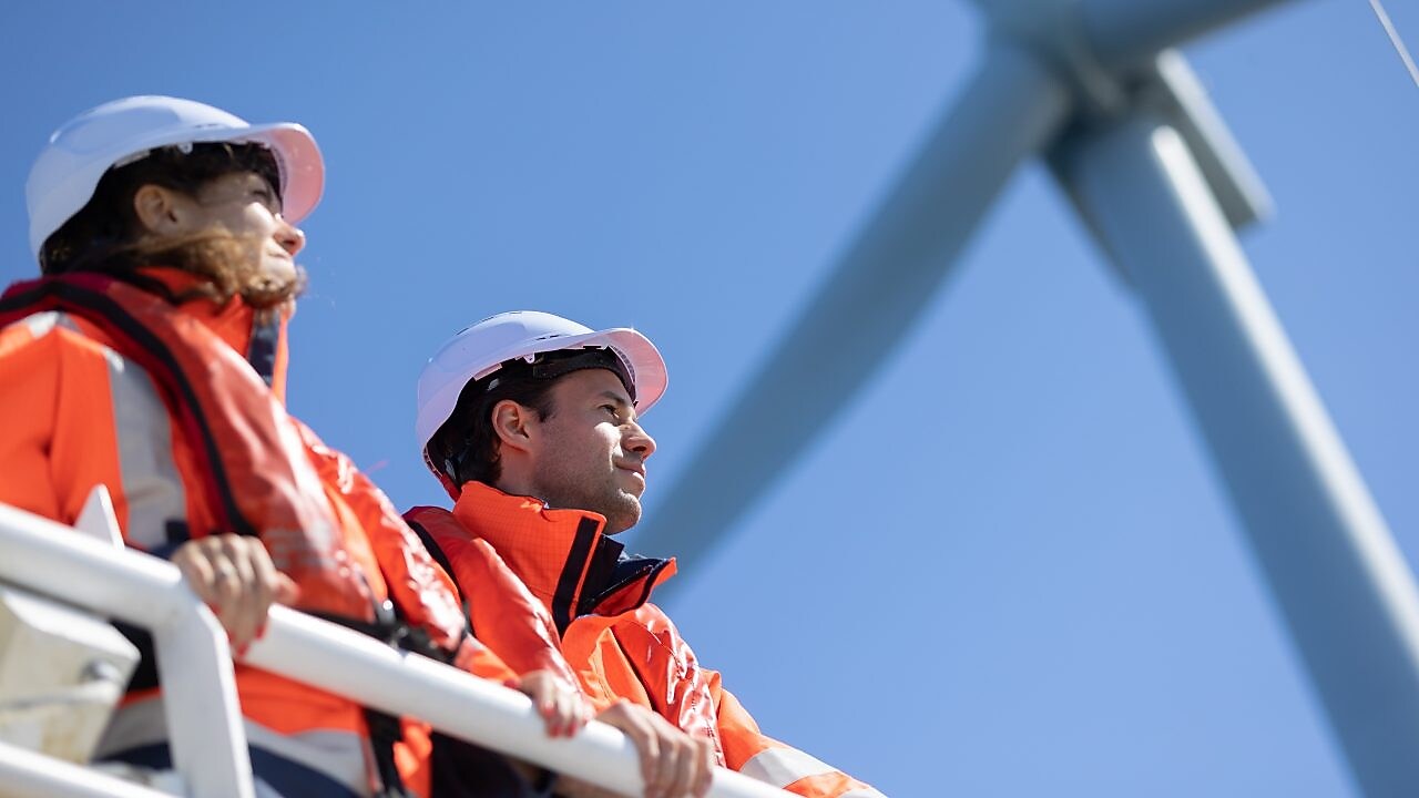 Wind technician standing outside of wind turbine