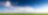 Photo of wind turbine in green landscape with blue skies