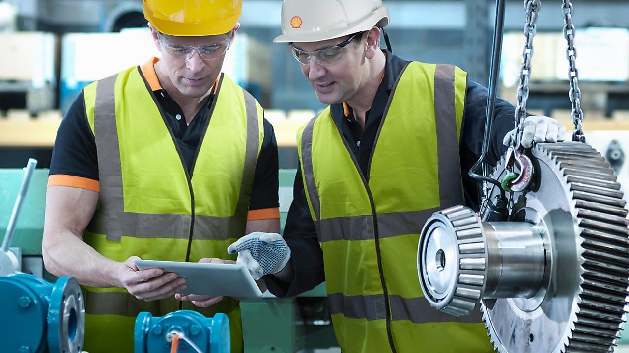 Shell worker consulting an industry worker on site