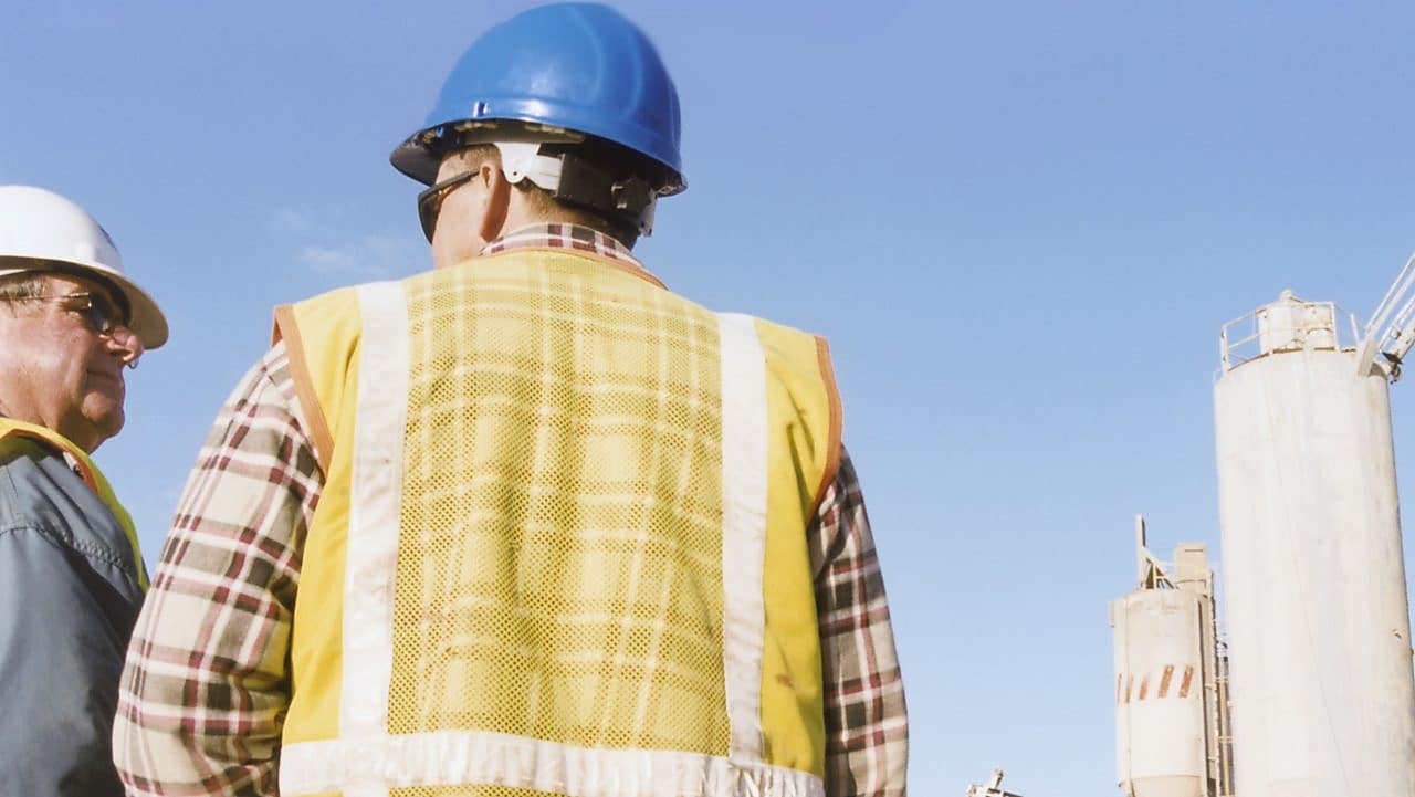 Men talking at a cement plant