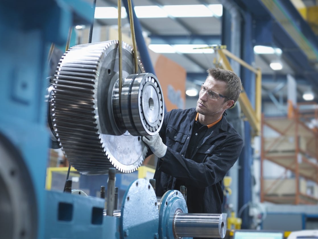 A Shell expert inspects and monitors a piece of machinery