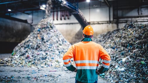 Male Worker in Protective Gear at Waste Processing Facility