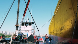 refuelling a tanker from a tug on the houston shipping channel