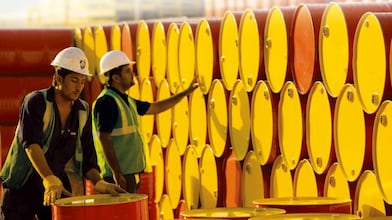 Workers counting barrels
