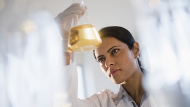Scientist in a lab pouring a lubricant