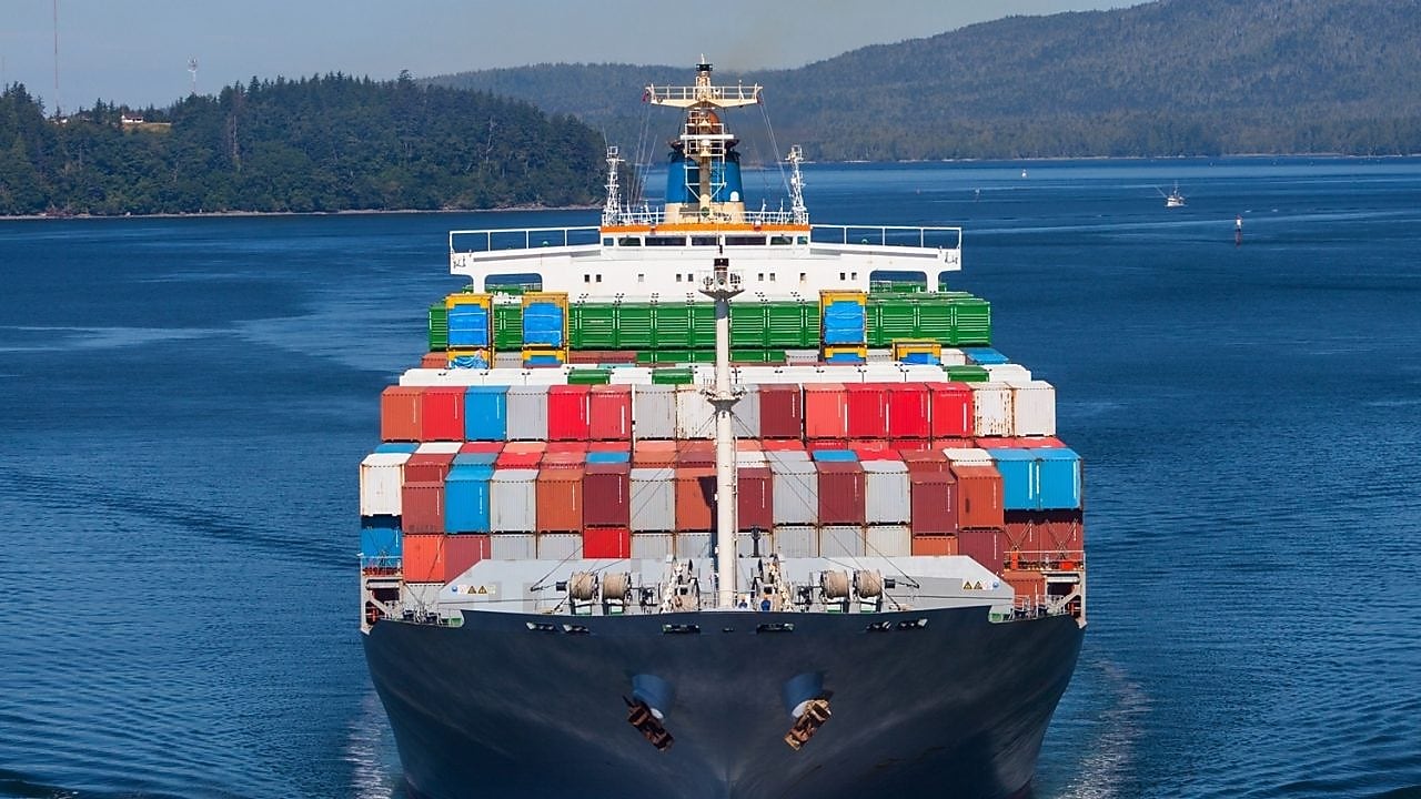 Refuelling a tanker from a tug on the Houston shipping channel, USA