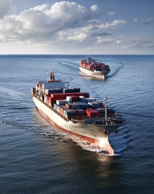 Two cargo vessels sailing in open sea