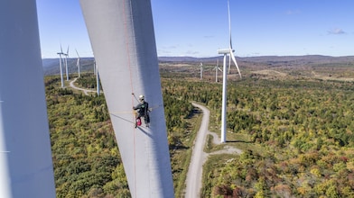 worker checking wind mill
