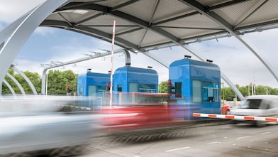 cars driving through a toll point