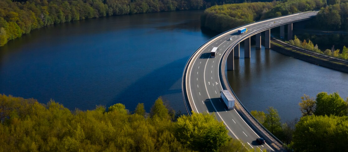 Trucks crossing bridge above water