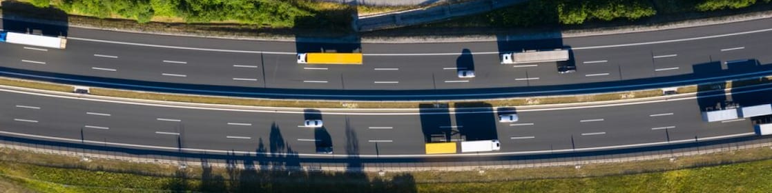 Aerial view of trucks and cars driving along a road