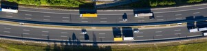 Aerial view of trucks and cars driving along a road