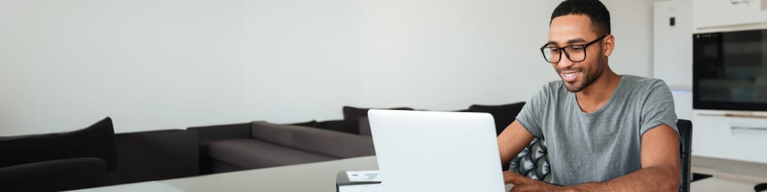 Man smiling working at his laptop