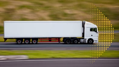 Heavy duty freight truck on a highway at sunrise