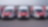 Three white and red delivery vans 