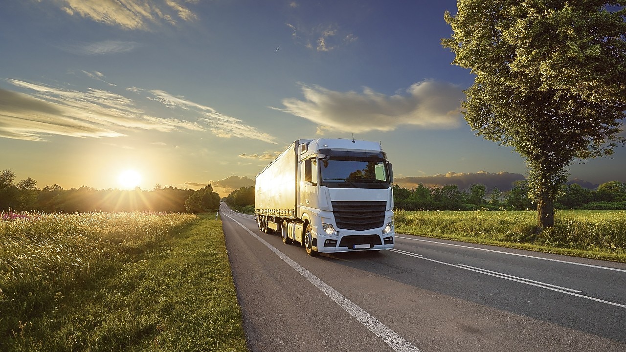 Truck driving at sunrise 