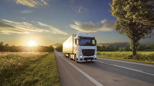 Truck driving at sunrise 