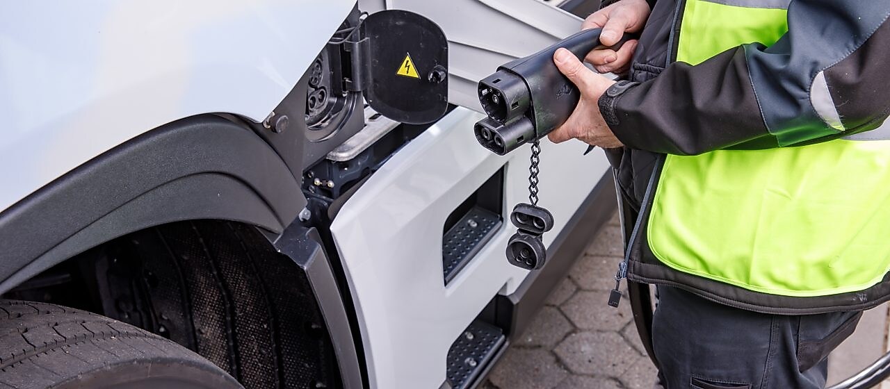 Driver plugging in truck