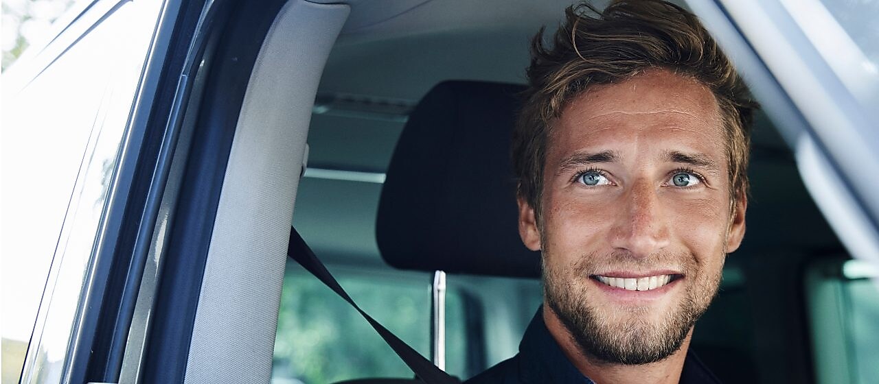 Man smiling in a car