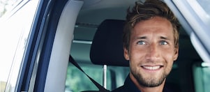 Man smiling in a car