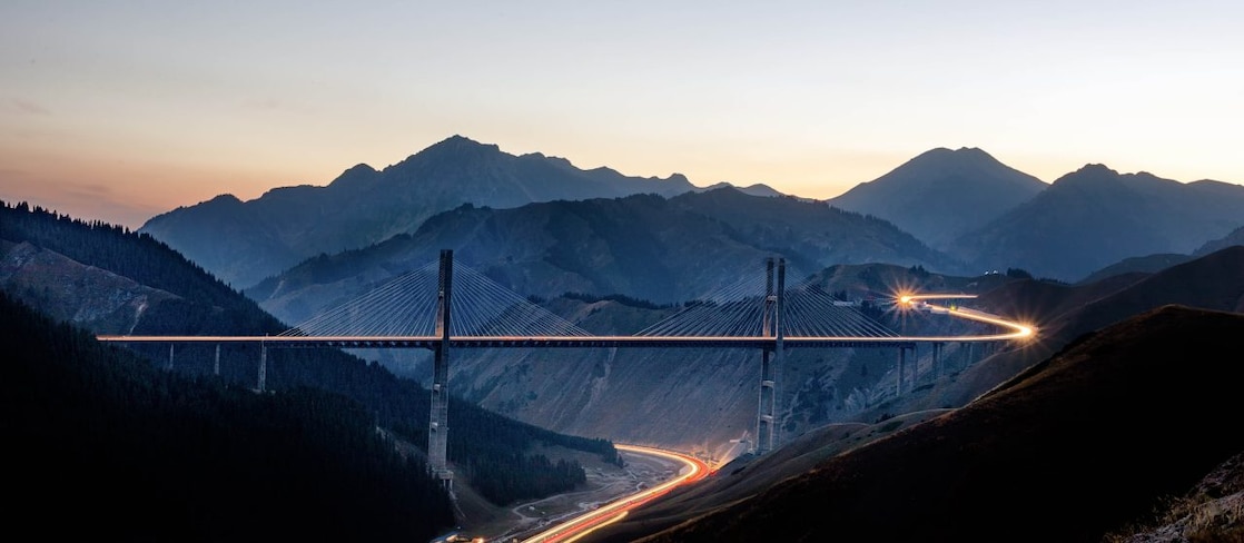 Brightly lit road though mountains