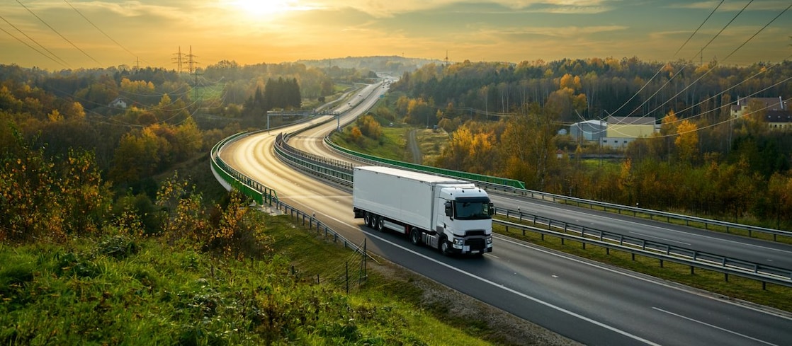 Multiple lane highway with semi trucks.