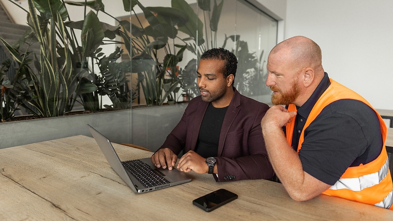 Workers Looking at Laptop