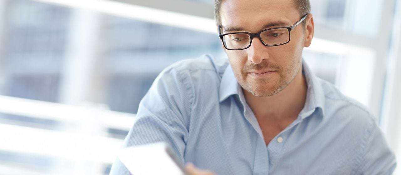 Man looking into the paper
